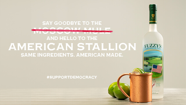 Advertisement with a bottle of Fuzzy’s vodka, limes, and a copper mug, promoting the ‘American Stallion’ cocktail as an alternative to the Moscow Mule