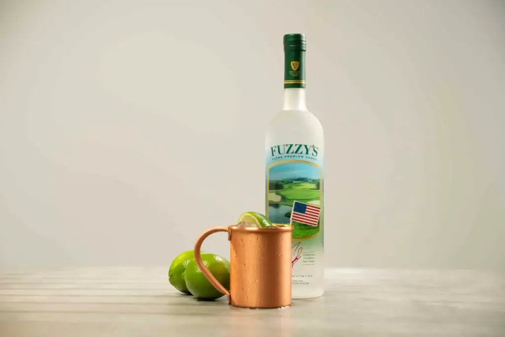 Fuzzy's Vodka bottle with a copper cup with American Stallion cocktail